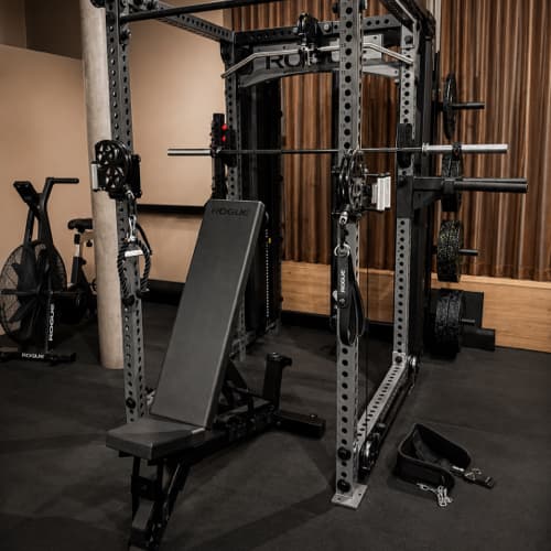 Rack of Rogue dumbbells, bars and bumper plates at SHIO